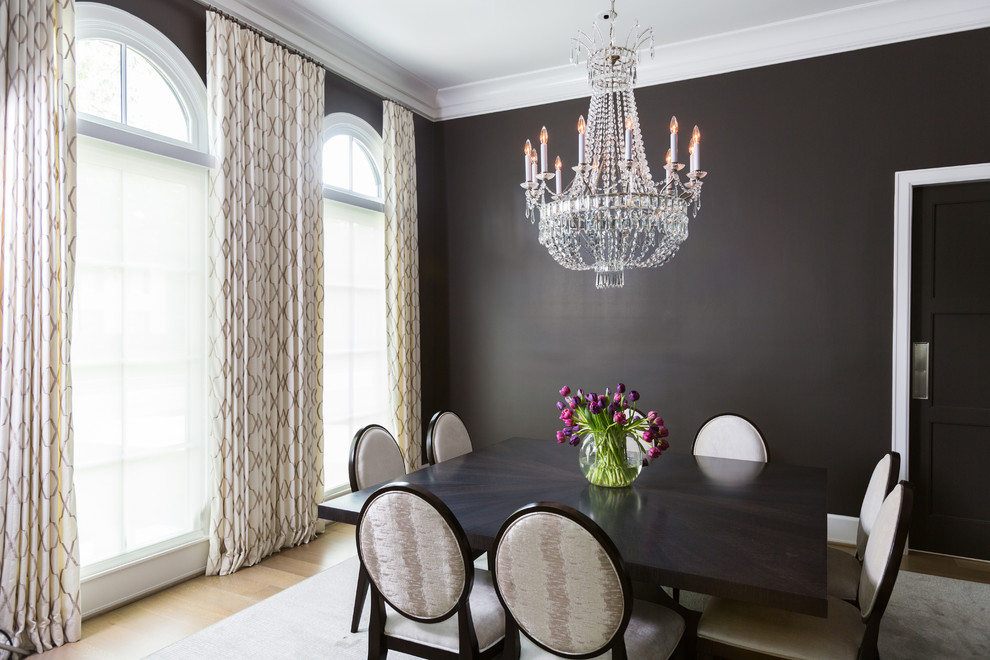 Large transitional separate dining room in Houston with black walls and porcelain floors.