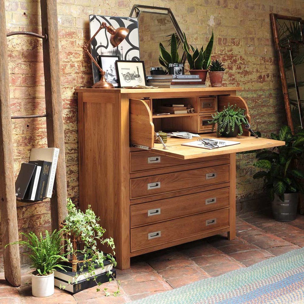 Country home office in Other with green walls, a freestanding desk and terra-cotta floors.