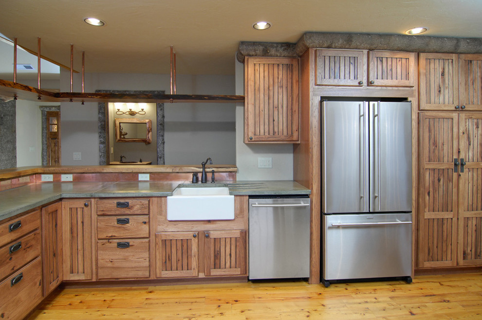 Inspiration for a large country l-shaped eat-in kitchen in Charlotte with a farmhouse sink, beaded inset cabinets, medium wood cabinets, concrete benchtops, blue splashback, metal splashback, stainless steel appliances, medium hardwood floors and with island.