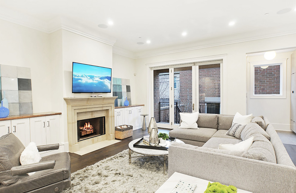 Design ideas for a large transitional open concept family room in Chicago with white walls, dark hardwood floors, a standard fireplace, a stone fireplace surround and a wall-mounted tv.
