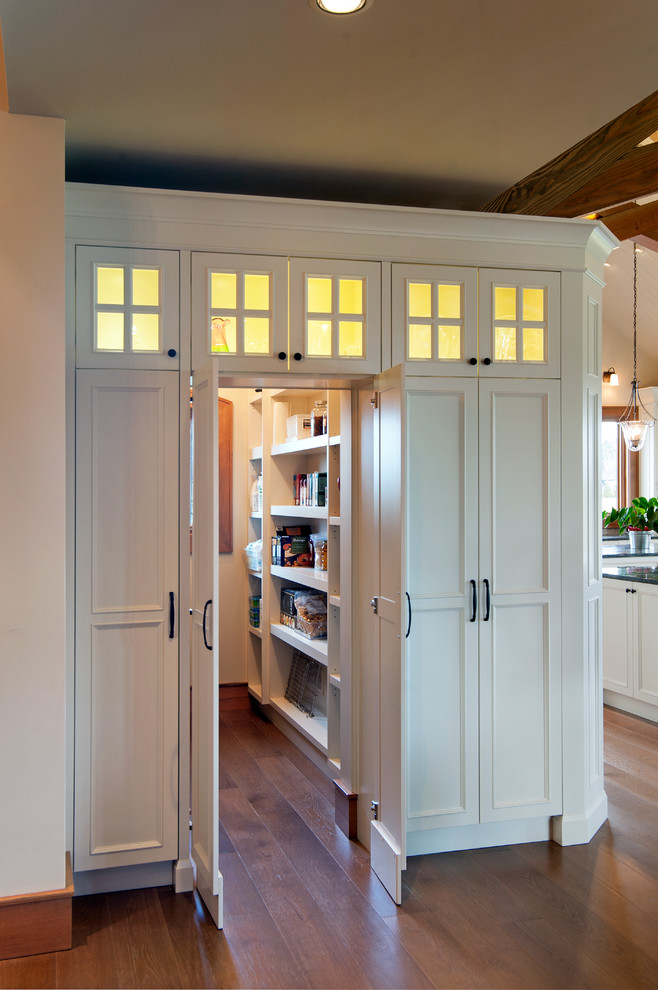 Traditional kitchen pantry in Vancouver with recessed-panel cabinets, white cabinets and medium hardwood floors.