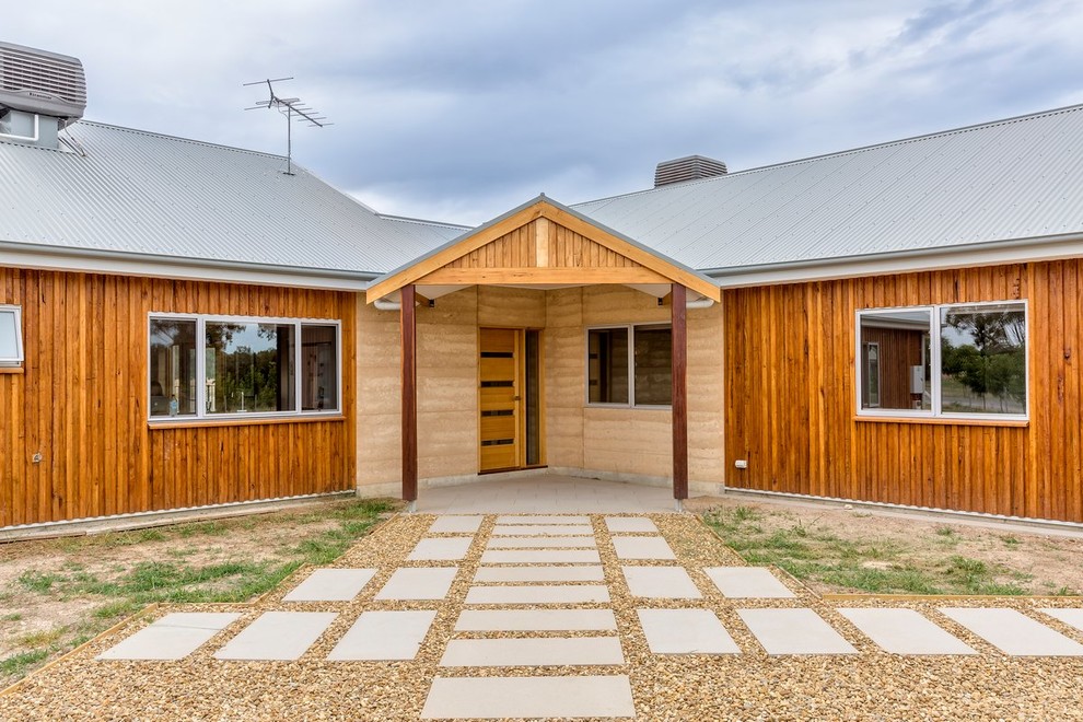 Rammed Earth &amp; Radial Timber in Town Farmhouse