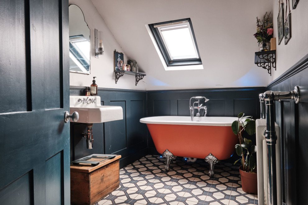 Design ideas for a mid-sized eclectic kids bathroom in London with a claw-foot tub, a shower/bathtub combo, a two-piece toilet, white walls, ceramic floors, a wall-mount sink, blue floor, a single vanity, a floating vanity, vaulted and panelled walls.