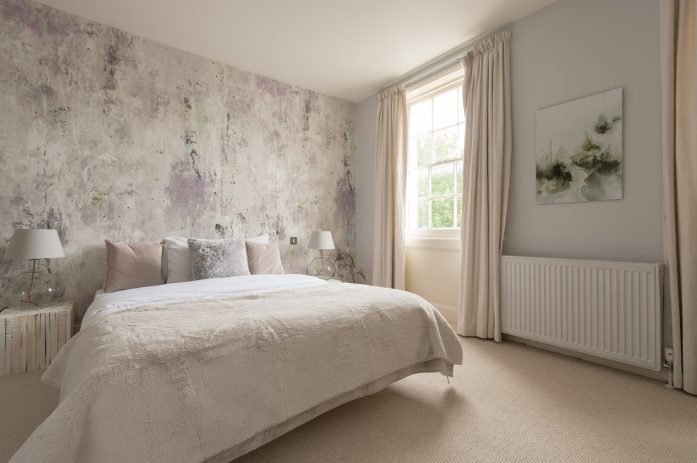 This is an example of a mid-sized contemporary bedroom in London with grey walls, carpet and beige floor.