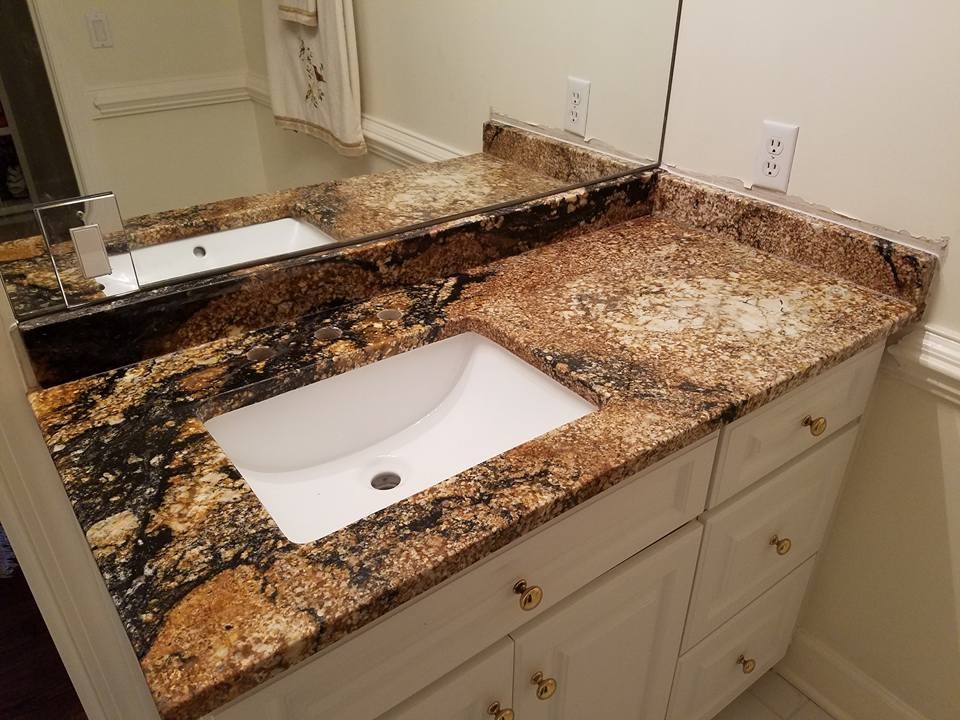 Example of a mid-sized classic 3/4 multicolored tile laminate floor and beige floor bathroom design in Atlanta with raised-panel cabinets, white cabinets, a one-piece toilet, white walls, an undermount sink and marble countertops