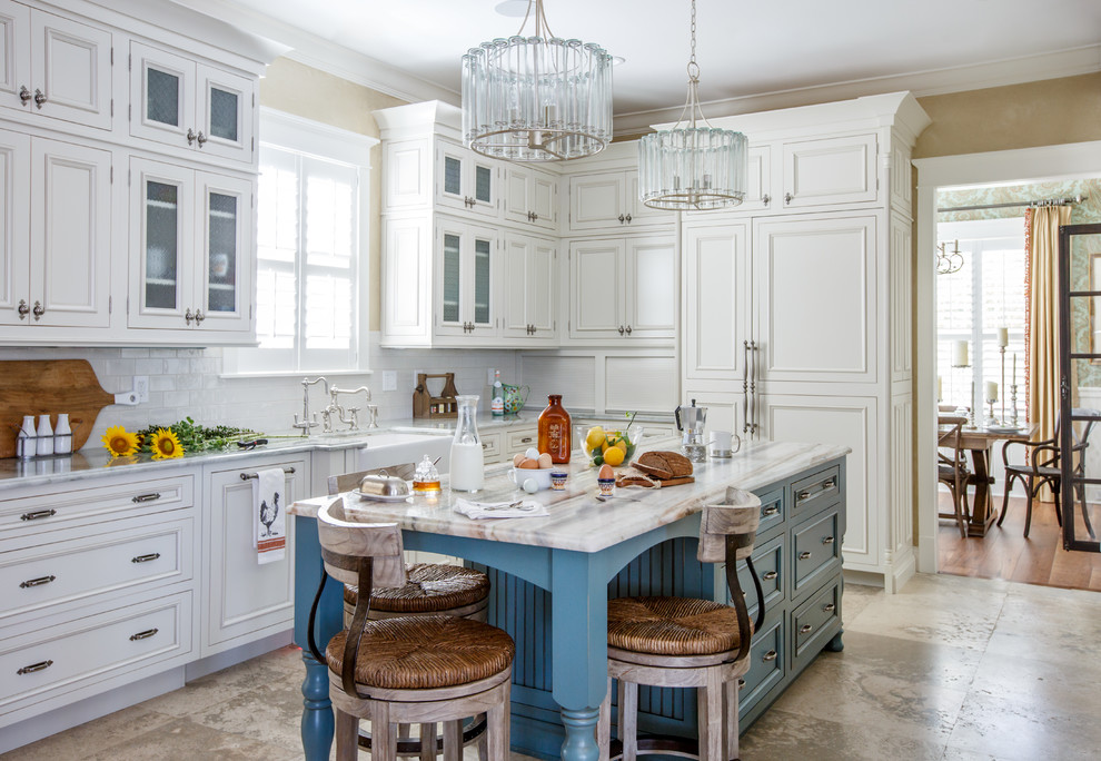 Inspiration for a mid-sized traditional separate kitchen in Jacksonville with a farmhouse sink, recessed-panel cabinets, white cabinets, subway tile splashback, panelled appliances, with island, green splashback, travertine floors and beige floor.