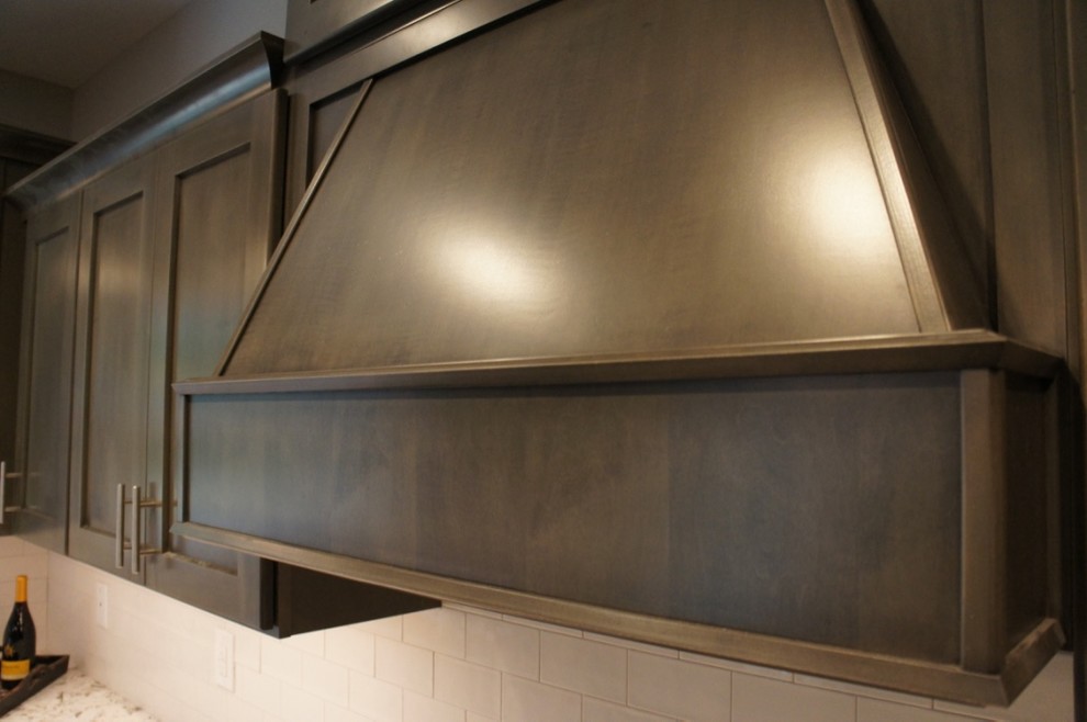 Inspiration for a transitional u-shaped eat-in kitchen remodel with a farmhouse sink, flat-panel cabinets, white backsplash, ceramic backsplash, stainless steel appliances and an island