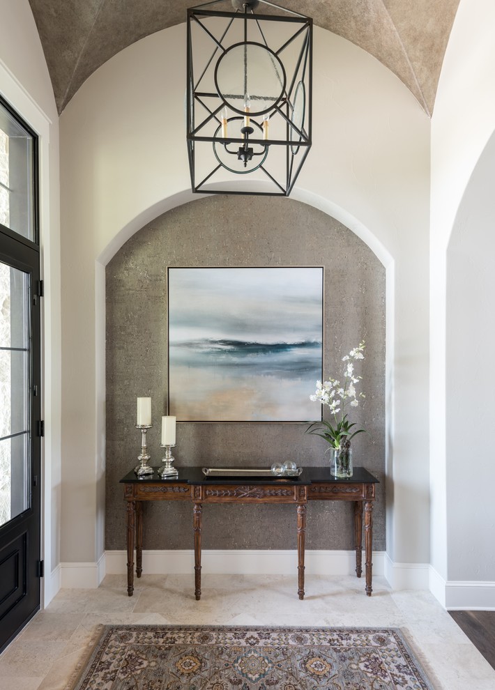 Inspiration for a mediterranean foyer in Austin with multi-coloured walls, a black front door and beige floor.