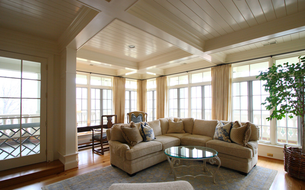 Design ideas for a transitional family room in DC Metro with beige walls and light hardwood floors.