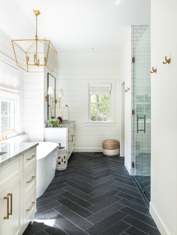 Inspiration for a large transitional master bathroom in Nashville with shaker cabinets, white cabinets, a freestanding tub, a curbless shower, a two-piece toilet, white tile, subway tile, white walls, slate floors, an undermount sink, marble benchtops, black floor, a hinged shower door, white benchtops, a niche, a single vanity, a built-in vanity, vaulted and planked wall panelling.