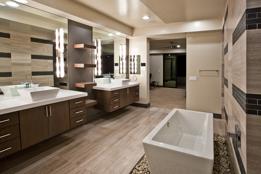 Expansive contemporary master bathroom in Las Vegas with flat-panel cabinets, brown cabinets, a freestanding tub, a vessel sink, solid surface benchtops, beige floor, white benchtops, a double vanity and a floating vanity.