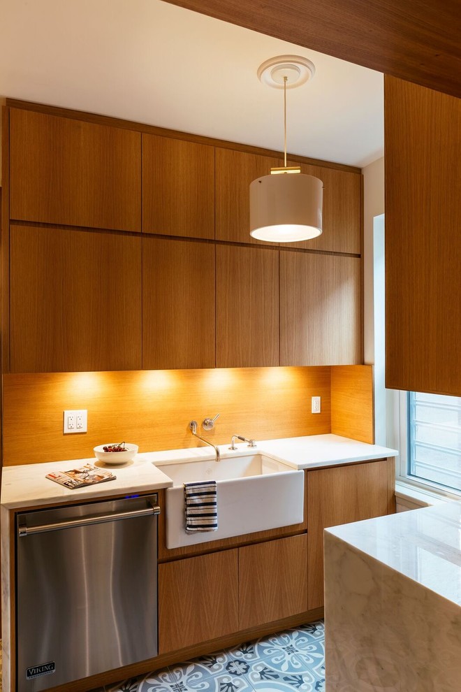 Design ideas for a large contemporary galley separate kitchen in New York with an integrated sink, flat-panel cabinets, light wood cabinets, marble benchtops, beige splashback, timber splashback, stainless steel appliances, ceramic floors, no island, multi-coloured floor, white benchtop and wallpaper.