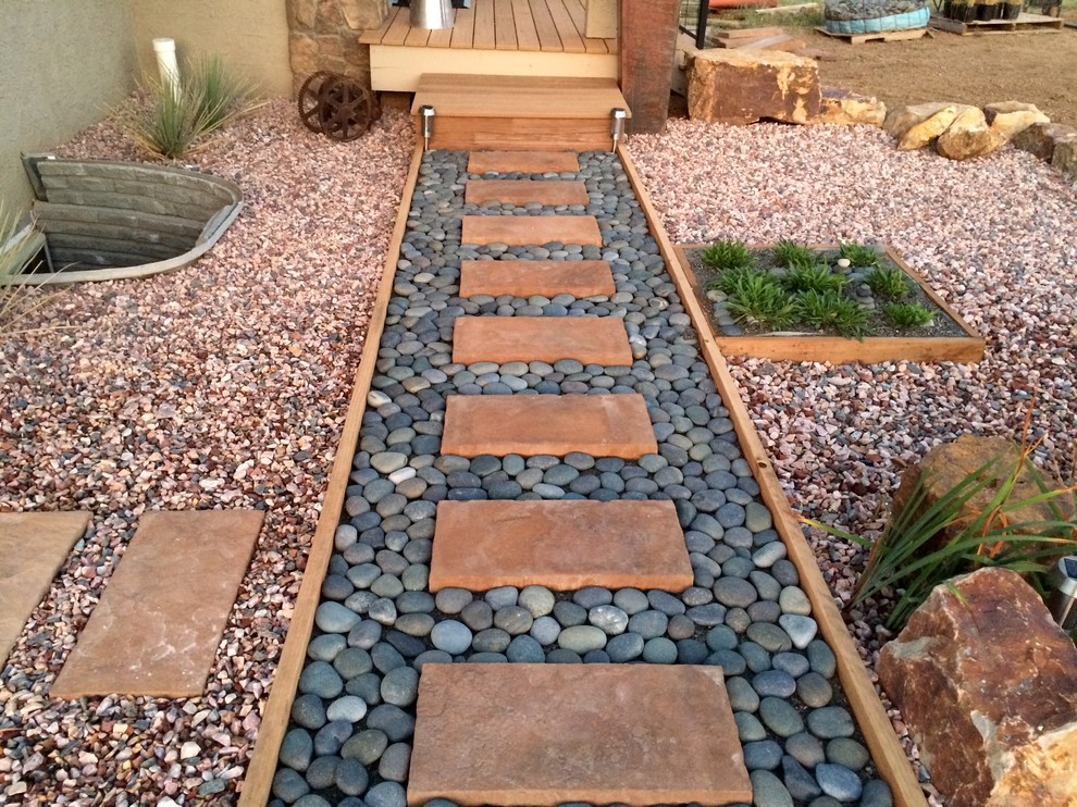 Photo of a mid-sized backyard full sun xeriscape for summer in Other with a garden path and gravel.
