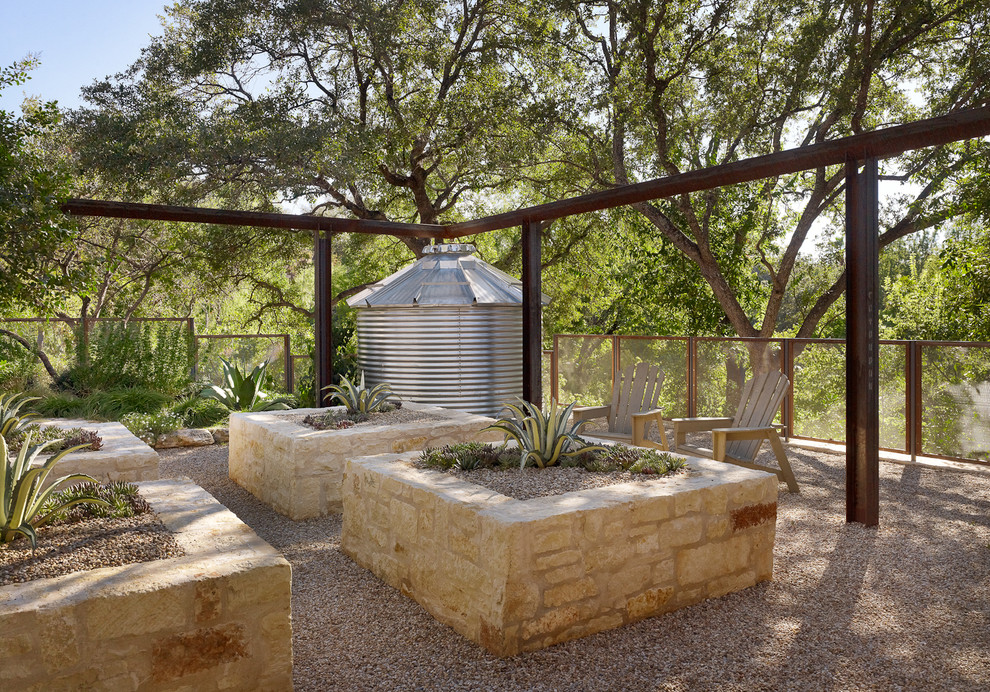 This is an example of a mediterranean garden in Austin with a container garden.