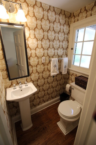 Small transitional powder room in St Louis with a pedestal sink and medium hardwood floors.