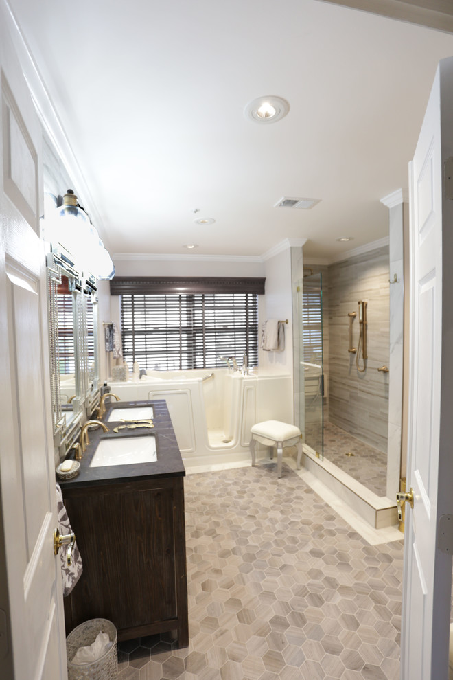 Design ideas for a large transitional master bathroom in DC Metro with flat-panel cabinets, medium wood cabinets, a freestanding tub, a double shower, a bidet, white tile, porcelain tile, white walls, porcelain floors, an undermount sink, soapstone benchtops, white floor, an open shower and black benchtops.