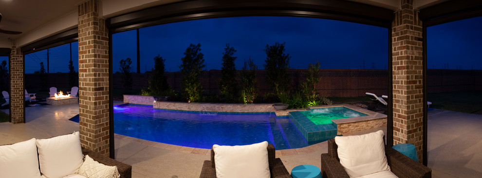 Inspiration for a large arts and crafts backyard rectangular pool in Houston with a hot tub and decking.