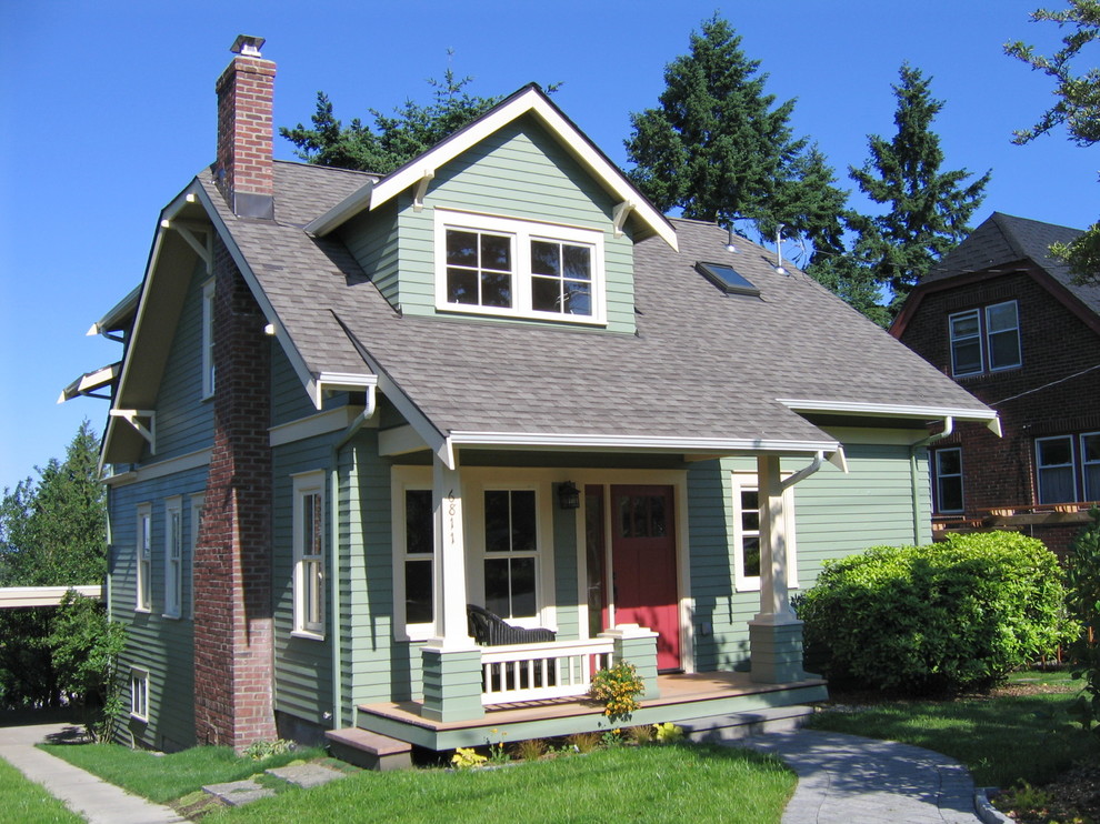 This is an example of a small traditional two-storey exterior in Seattle with wood siding.