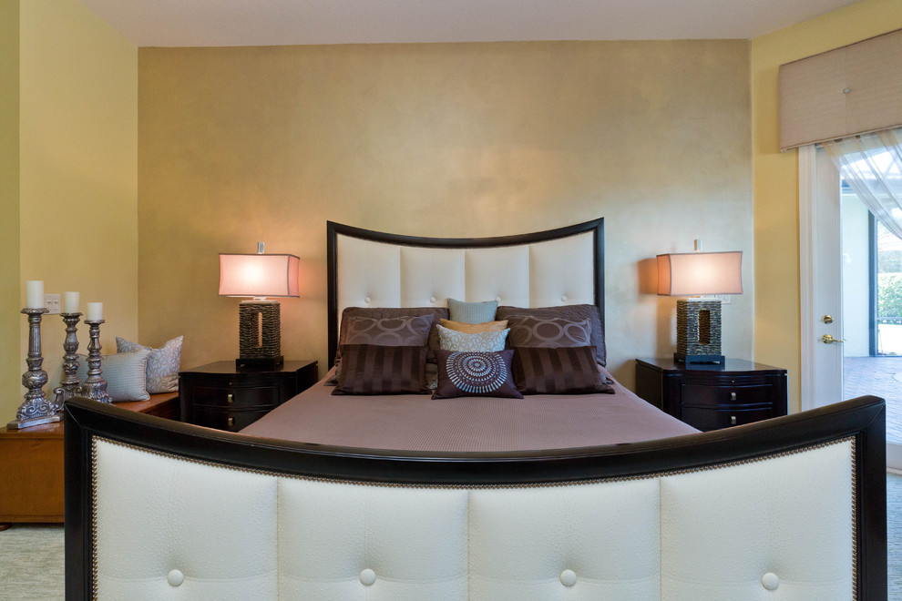 Design ideas for a mid-sized transitional guest bedroom in Miami with beige walls and carpet.