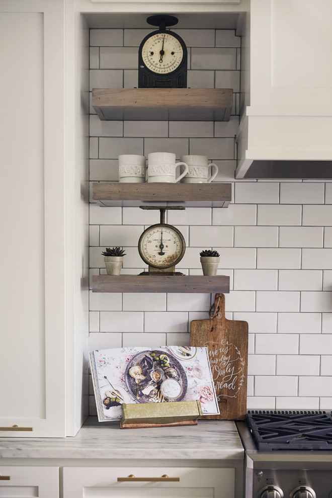 Inspiration for a huge rustic l-shaped medium tone wood floor eat-in kitchen remodel with a farmhouse sink, shaker cabinets, white cabinets, white backsplash, subway tile backsplash, stainless steel appliances, an island and white countertops
