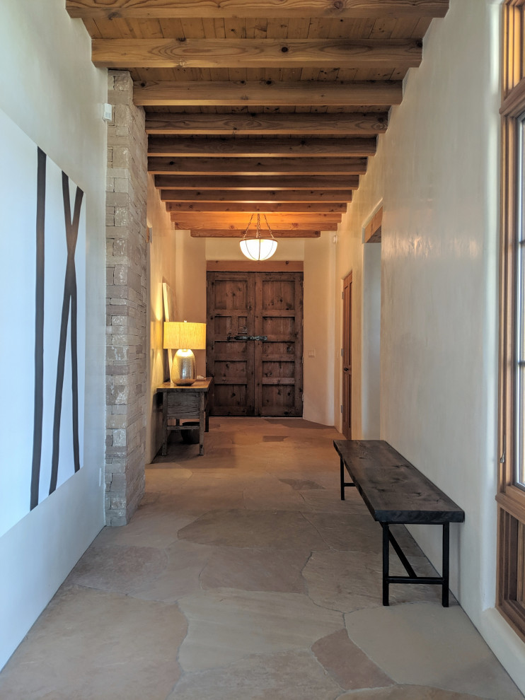 Large foyer in Other with beige walls, a double front door, a medium wood front door and pink floor.