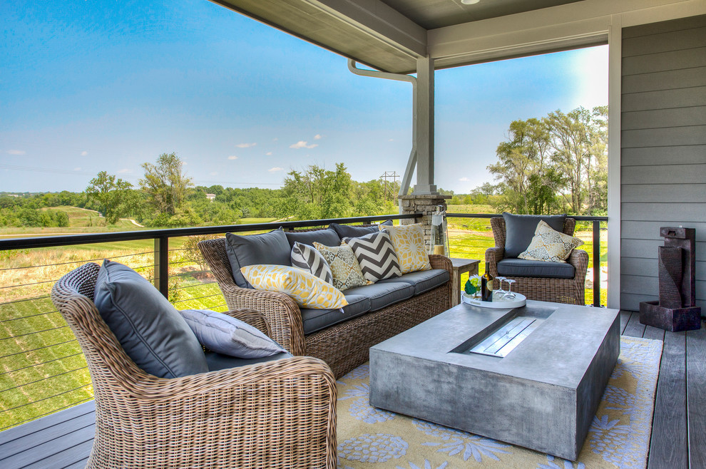 Large transitional backyard deck photo with a roof extension