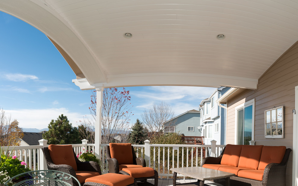Inspiration for a mid-sized transitional backyard deck in Denver with a roof extension.
