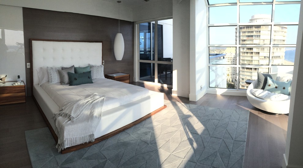 This is an example of a large modern master bedroom in Los Angeles with white walls, bamboo floors and no fireplace.