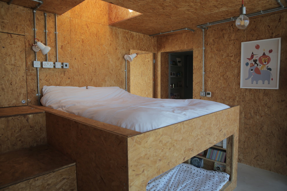 Small industrial gender-neutral kids' bedroom in London with beige walls and grey floor.