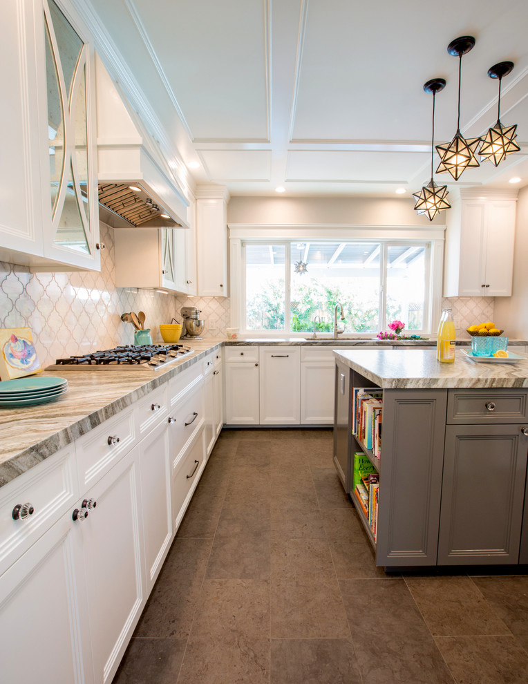Mid-sized transitional u-shaped kitchen in Los Angeles with an undermount sink, recessed-panel cabinets, white cabinets, granite benchtops, white splashback, marble splashback, stainless steel appliances, porcelain floors, with island and grey floor.