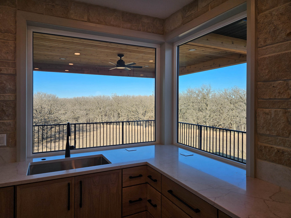 Inspiration for a large u-shaped medium tone wood floor eat-in kitchen remodel with recessed-panel cabinets, light wood cabinets, quartz countertops, an island, an undermount sink, quartz backsplash and stainless steel appliances
