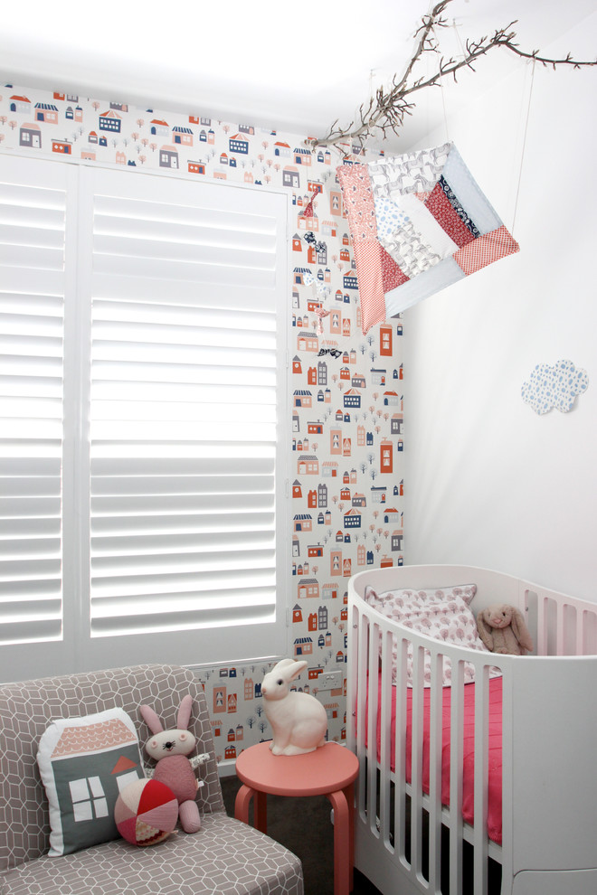 Design ideas for a contemporary nursery for girls in Melbourne with white walls.