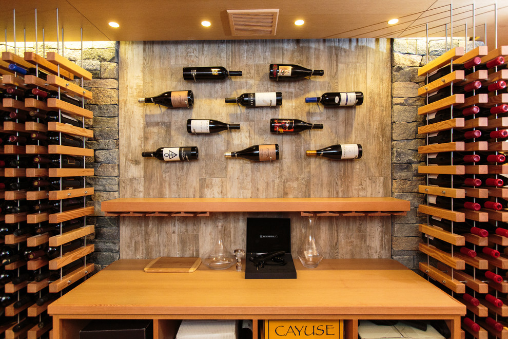Transitional wine cellar in Boston with medium hardwood floors, storage racks and brown floor.