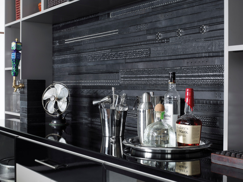 This is an example of a mid-sized contemporary single-wall wet bar in Nashville with no sink, glass-front cabinets, black cabinets, granite benchtops, black splashback and concrete floors.