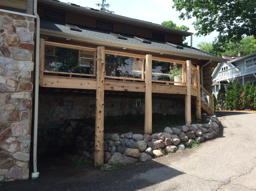 Mid-sized mountain style backyard deck photo in Milwaukee with no cover