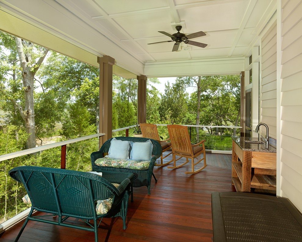 Design ideas for a contemporary side yard screened-in verandah in Charleston with a roof extension.