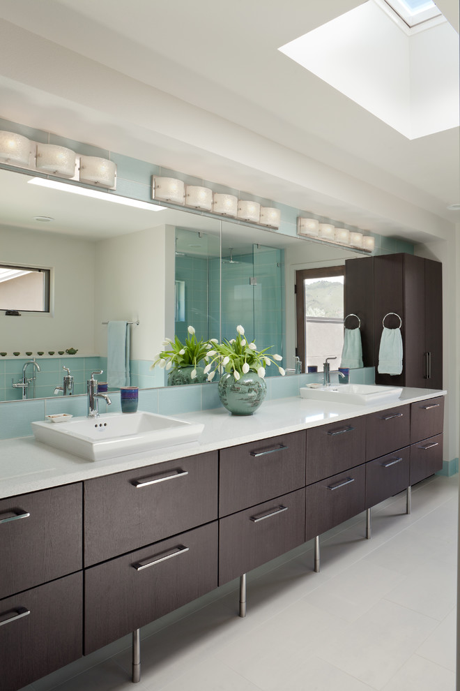 Large contemporary master bathroom in Denver with flat-panel cabinets, dark wood cabinets, blue tile, glass tile, ceramic floors, white walls, a vessel sink, engineered quartz benchtops, white floor and white benchtops.