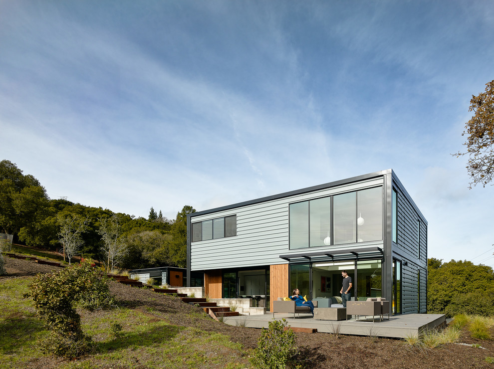 Design ideas for a contemporary two-storey blue house exterior in San Francisco with a flat roof.