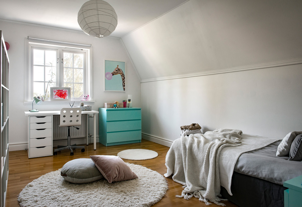 Mid-sized scandinavian gender-neutral kids' bedroom in Stockholm with white walls.