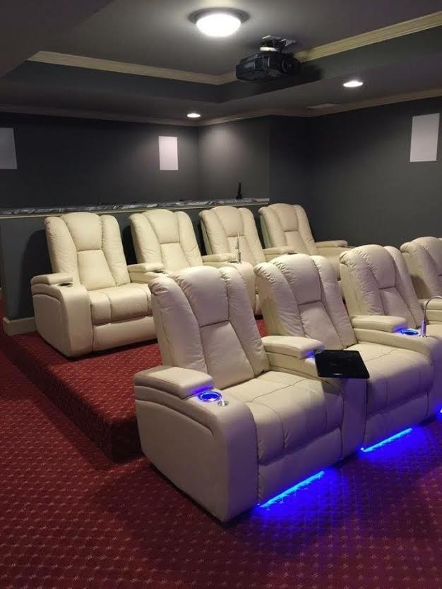 Mid-sized transitional enclosed home theatre in Atlanta with grey walls, carpet, a projector screen and red floor.
