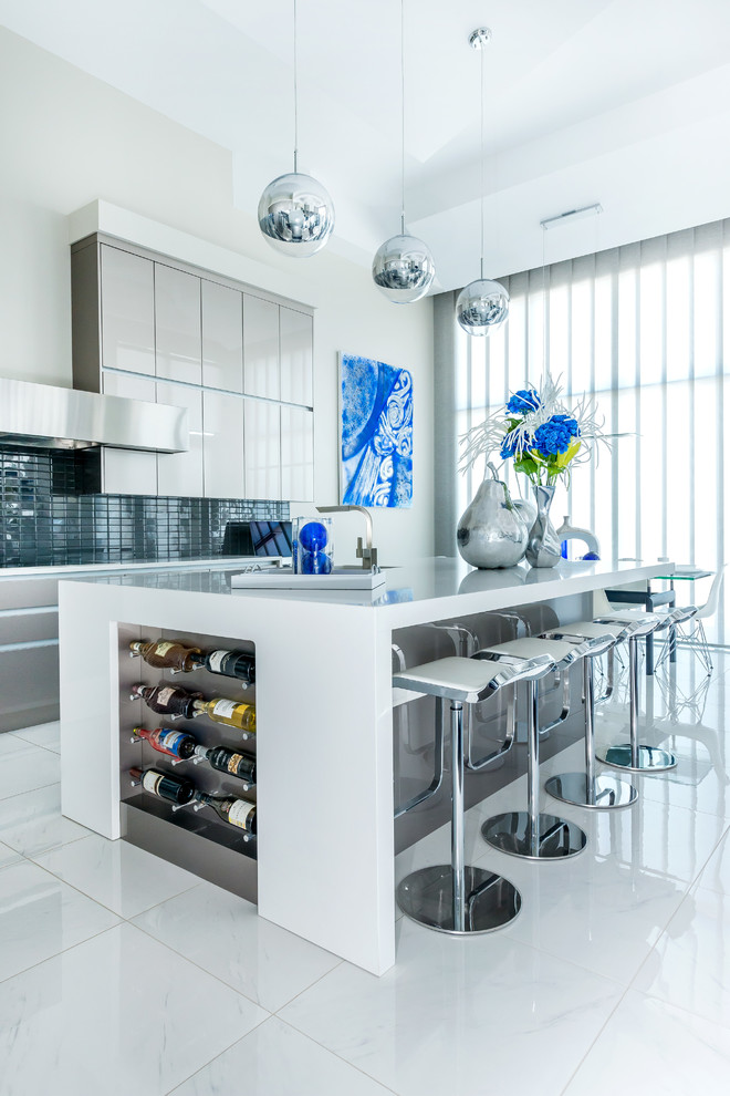 Photo of a large contemporary l-shaped eat-in kitchen in Calgary with an undermount sink, flat-panel cabinets, grey cabinets, quartz benchtops, grey splashback, glass tile splashback, stainless steel appliances, porcelain floors, with island and white floor.