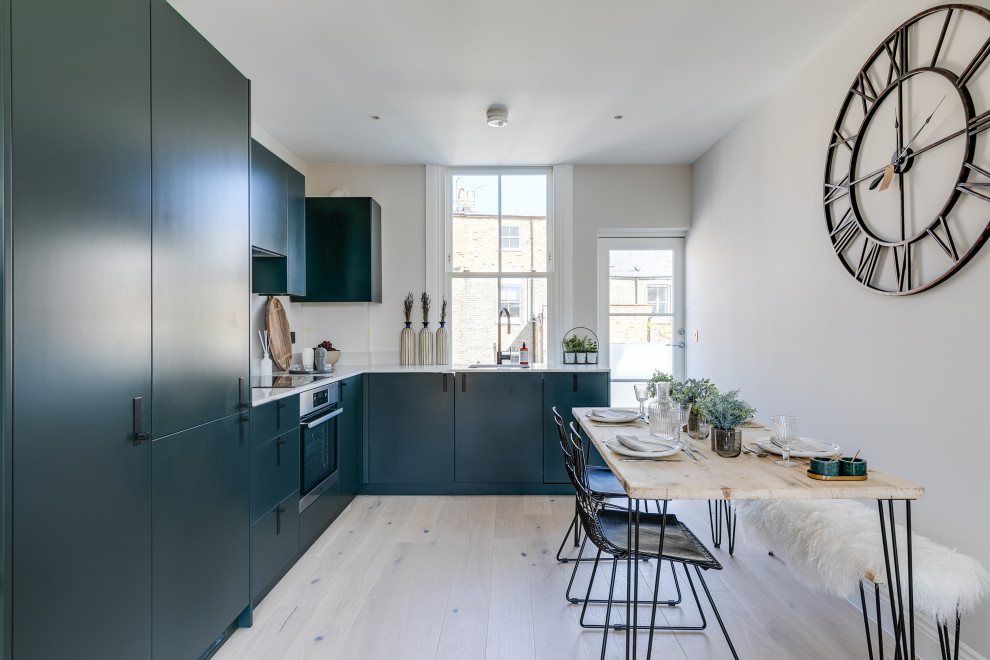 Photo of a contemporary grey and teal kitchen in London.