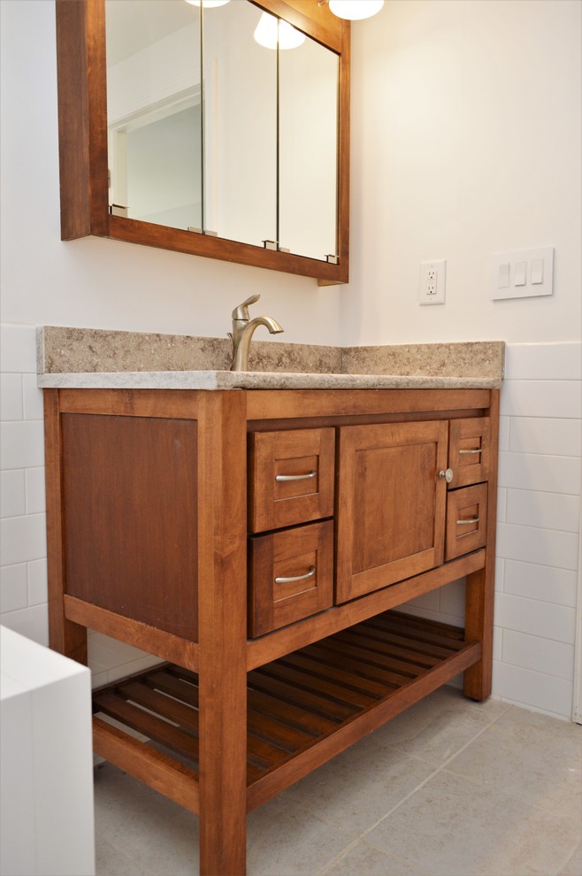 This is an example of a mid-sized traditional master bathroom in Chicago with shaker cabinets, medium wood cabinets, white tile, subway tile, white walls, an undermount sink, quartzite benchtops and beige benchtops.
