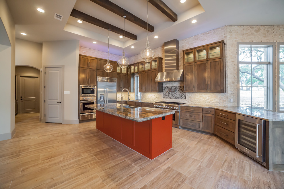 Design ideas for a large contemporary l-shaped open plan kitchen in Austin with a farmhouse sink, shaker cabinets, dark wood cabinets, onyx benchtops, beige splashback, stone tile splashback, stainless steel appliances, porcelain floors, with island and beige floor.