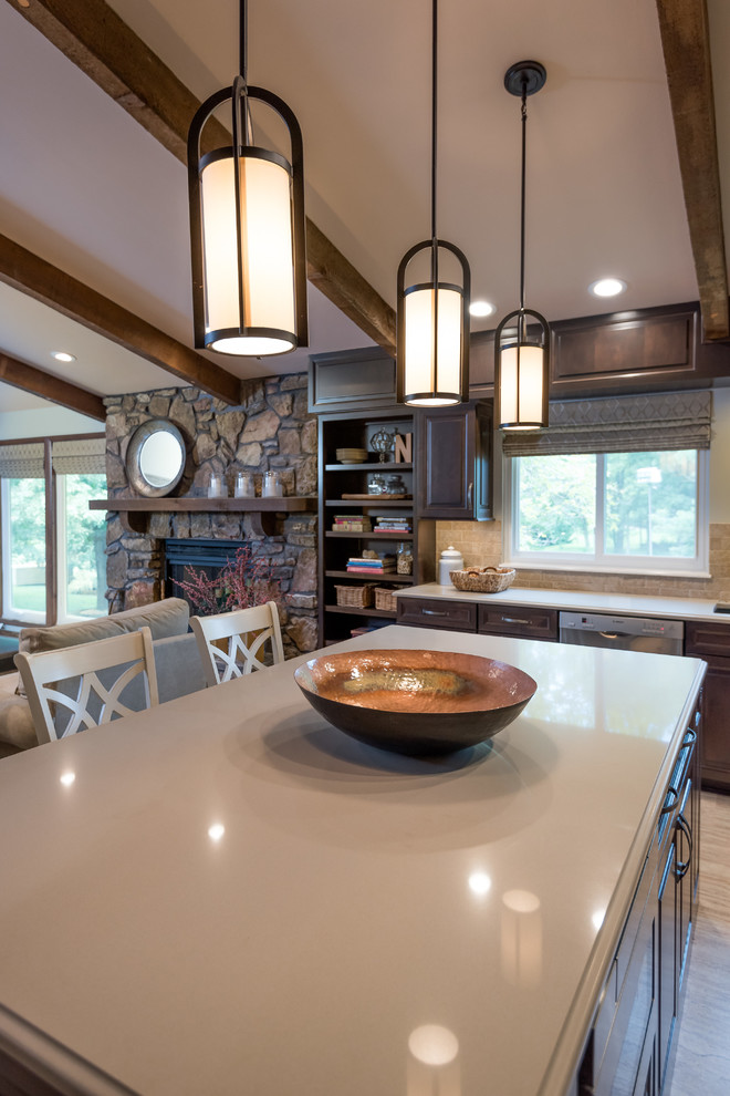 Inspiration for a transitional cork floor kitchen remodel in St Louis with an undermount sink, raised-panel cabinets, dark wood cabinets, beige backsplash, stainless steel appliances and an island