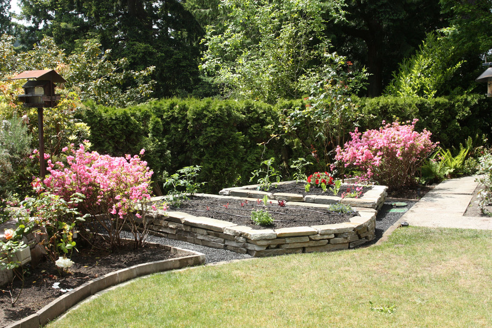 Mid-sized mediterranean backyard full sun garden in Seattle with a vegetable garden and concrete pavers for spring.