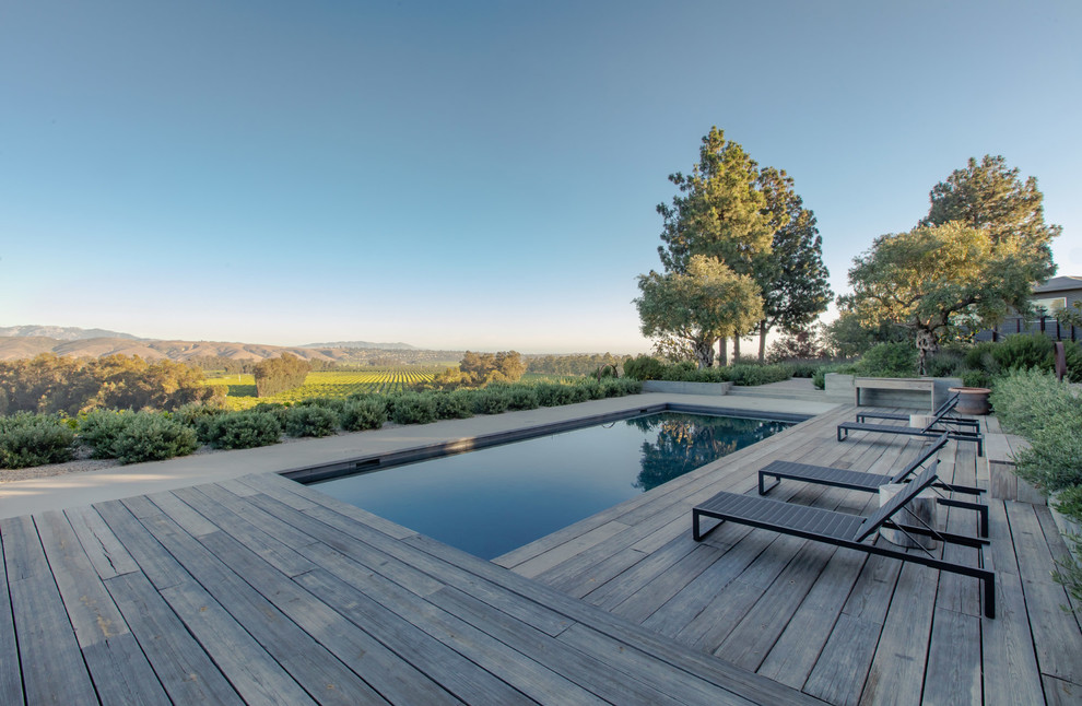 Mid-sized contemporary backyard rectangular lap pool in Santa Barbara with decking.