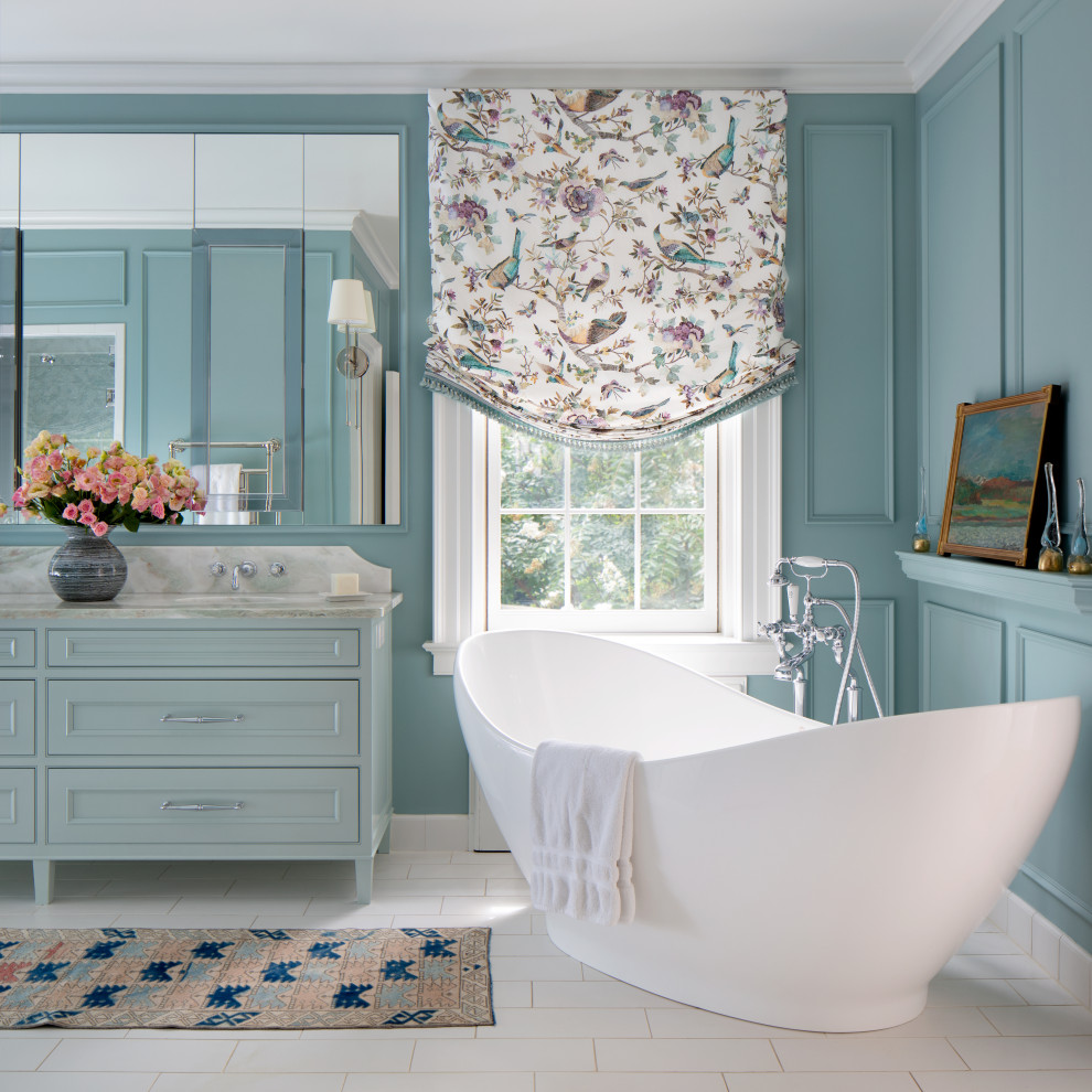 Photo of a large traditional master bathroom in Richmond with beaded inset cabinets, blue cabinets, a double vanity, a freestanding vanity, a freestanding tub, blue walls, an undermount sink, white floor and panelled walls.