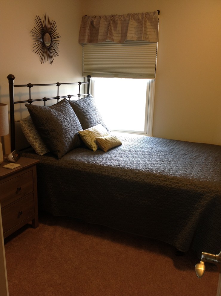 Example of a transitional guest carpeted bedroom design with beige walls