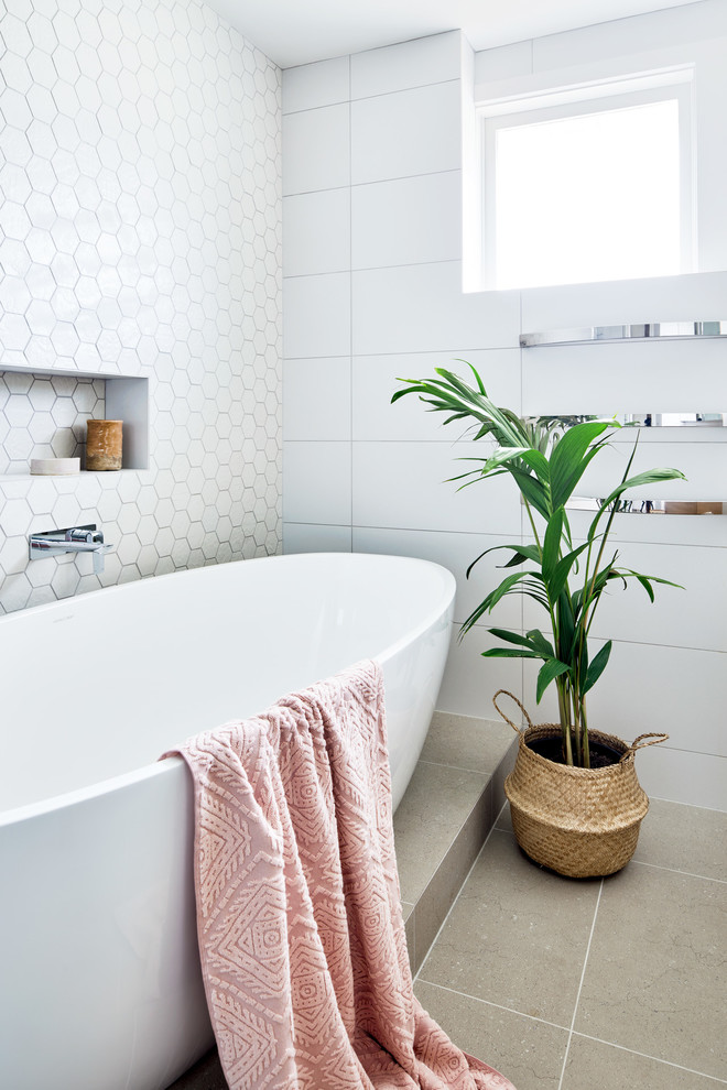 Inspiration for a mid-sized contemporary master bathroom in Melbourne with a freestanding tub, a corner shower, a wall-mount toilet, white tile, ceramic tile, white walls, ceramic floors, an undermount sink, engineered quartz benchtops, brown floor, a hinged shower door and white benchtops.